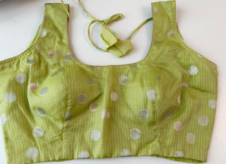 Handcrafted pastel green Zari Kota blouse with fine hand detailing, round neckline, and elbow-length sleeves, available in sizes 36–44.