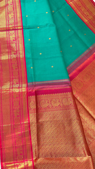 Detailed close-up of the vaira oosi weaving pattern on pure Kanchivaram silk saree in pink and teal shades with silver zari threads.