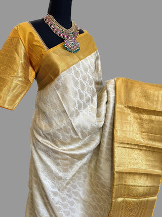 Traditional Ven Pattu Kanjivaram silk saree in elegant off-white shade with rich woven detailing, perfect for South Indian weddings, temple ceremonies, and festive occasions, featuring luxurious silk texture and classic heritage craftsmanship.