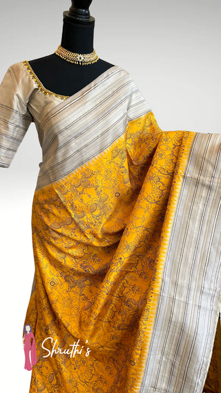 Pure handloom silk saree with multicolor Kalamkari hand-painted design and readymade blouse, ideal for Indian weddings.