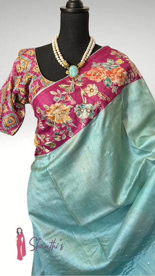Pure Tussar silk partywear saree with pastel body and contrasting floral embroidery.
