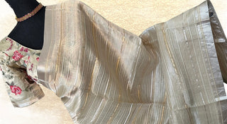 Pastel gold organza tissue saree with designer embroidered blouse included.