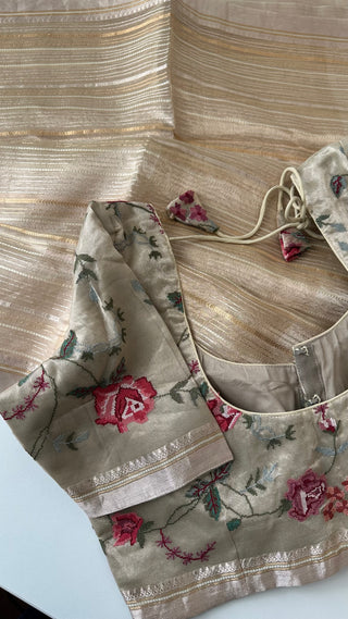 Beige tissue organza saree with subtle golden shine and fall pico finish.