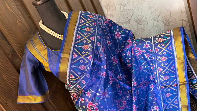 Pure silk blue patola saree with hand embroidered white cream prestitched blouse
