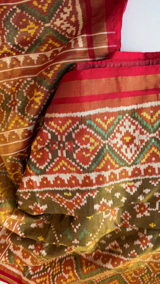 Bridal Patola saree crafted in pure silk with gold zari weaving, elegant pallu, and luxurious drape, suitable for grand wedding occasions.