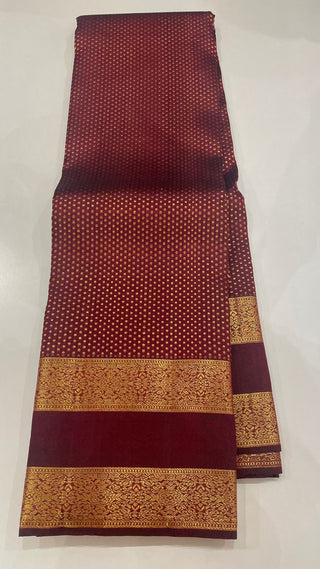 Classic Kanchipuram pattu saree in dark burgundy hue, featuring fine weaving, pure zari, and a prestitched embroidered blouse.