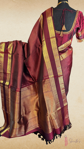 Traditional Kanchipuram pattu saree in rich burgundy with pure gold zari and modern stitched blouse design, perfect for wedding ceremonies.