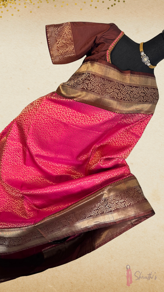 Luxurious double-ply soft silk saree with smooth drape, traditional temple-inspired motifs, and ready-stitched blouse.