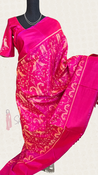 Luxurious double-threaded pink Patola silk saree featuring intricate weaves and a smooth, soft silk finish.