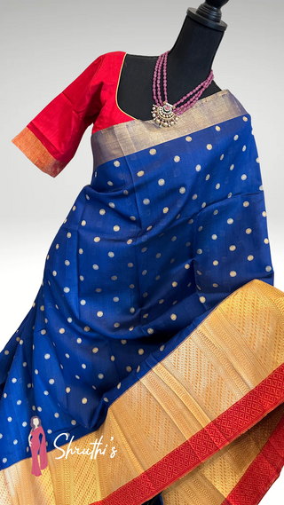 Royal blue organza silk saree with traditional zari border design.