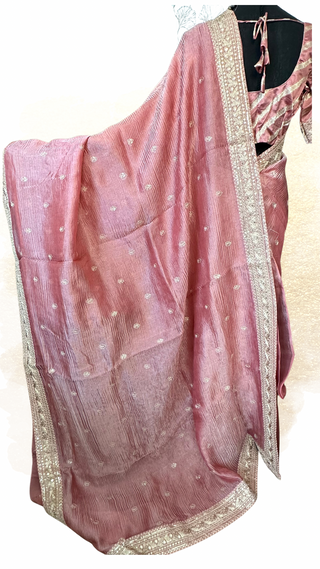 Lightweight crushed tissue saree displayed with matching prestitched blouse