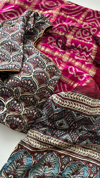 Pink pure silk Bandhani saree draped with Ajrakh Gajji silk pallu, perfect for festive wear.