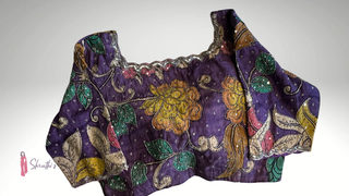 Violet soft cotton blouse with hand-painted Kalamkari designs and embroidery.