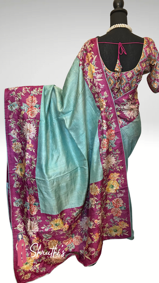 Pure Tussar silk saree in pastel blue with magenta floral embroidered border and blouse.