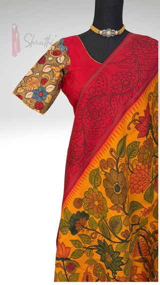 Traditional South Indian handwoven Kanjivaram saree featuring detailed pen kalamkari work, rich zari border and contrast blouse.