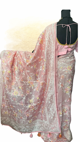Handloom pastel pink Kota saree showcasing fine embroidery and elegant woven design.