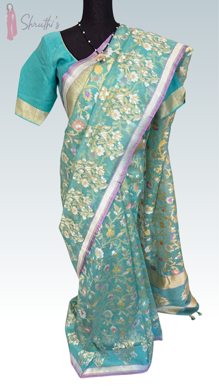 Elegant turquoise Banaras Kora Iktara pure silk saree with gold zari border and prestitched blouse, perfect for weddings, parties, and festive occasions.