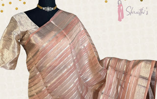 Exquisite handloom pink tissue silk saree featuring pure zari work and lined blouse up to size 42.