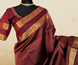 Finest handwoven burgundy Kanjivaram silk saree with soft texture, pure zari detailing, and prestitched embroidered blouse.