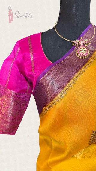 Exquisite Banaras organza silk saree in yellow and pink hues, handwoven with pure gold zari and soft transparent texture.