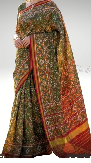 Authentic Patan Patola silk saree crafted with hand-dyed threads and woven with gold zari, featuring a smooth silk finish pallu and detailed craftsmanship.