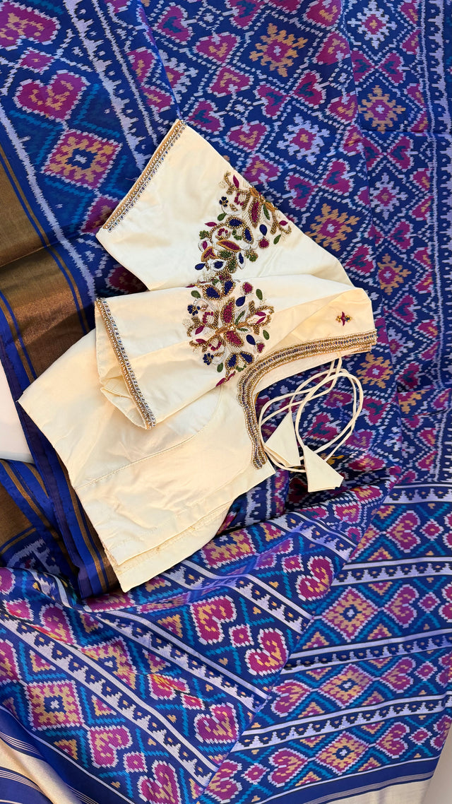 Pure silk indigo blue patola saree paired with hand embroidered white prestitched blouse