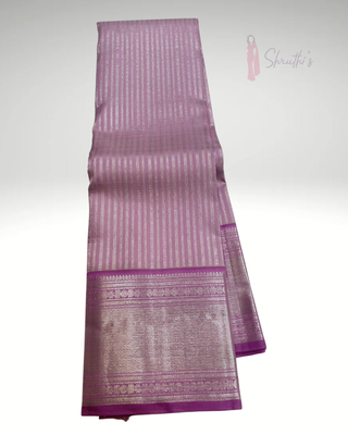 Pure handloom lavender Kanjivaram silk saree with elegant silver zari weaving, traditional heavy pallu, and custom blouse stitching perfect for weddings and festive occasions.