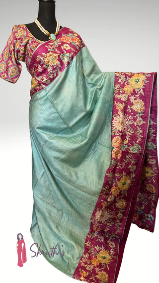 Pastel blue Tussar silk saree draped with embroidered blouse and border.