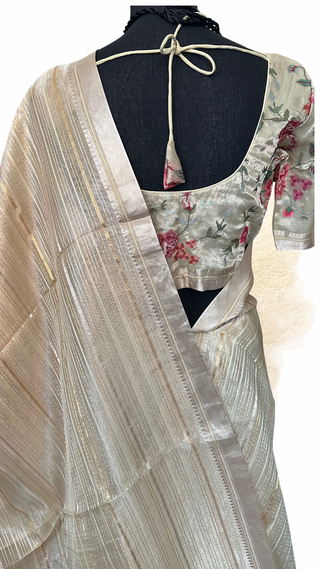 Luxury gold tissue silk saree with intricate embroidery and adjustable stitched blouse.