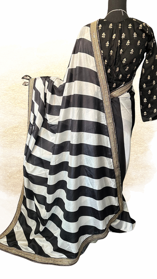 Soft silk black and white saree with gold thread border work