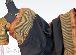 Elegant black and gold Maheshwari silk cotton saree with red zari border and pre-stitched blouse, soft drape and classic finish.