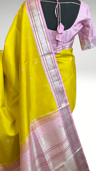 Lightweight pastel Kanjivaram pattu saree featuring silver zari work, soft drape, and stitched blouse, ideal for festive wear.