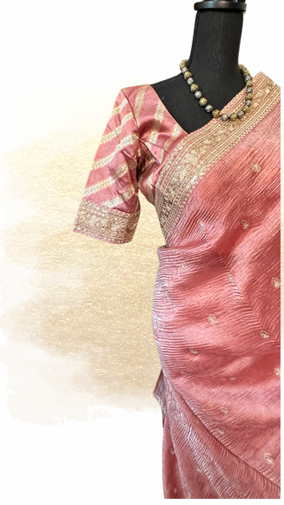 Pastel peach crushed tissue silk saree with embroidered blouse and soft drape