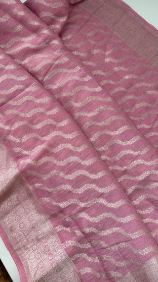Pastel pink pure linen Banarasi saree with elegant silver zari border, stitched blouse, and ready-to-wear fall and pico finish.