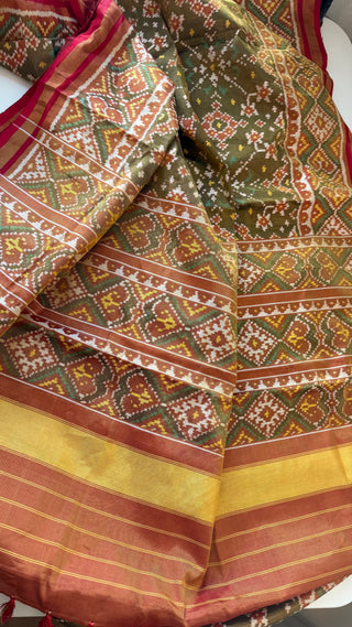 High-end Patola silk saree with intricate ikat patterns, soft silk finish, and embroidered pre-stitched blouse for a complete ethnic ensemble.