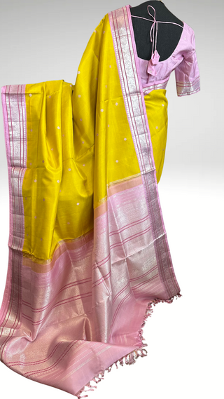 Authentic handwoven Kanchi pattu saree in pastel tones with silver zari border, perfect for bridal and wedding occasions.