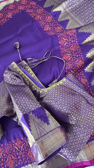 Pure Kanjivaram pattu saree in luxurious purple shade enhanced with fine embroidery and traditional gold borders