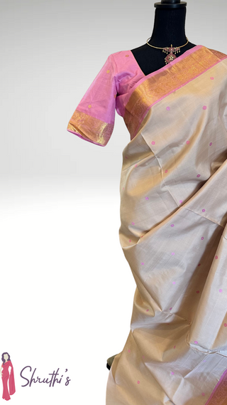 Pure Kanjivaram Ven Pattu silk saree in pastel pink with intricate silver zari border and hand-embroidered stitched blouse, perfect for weddings.