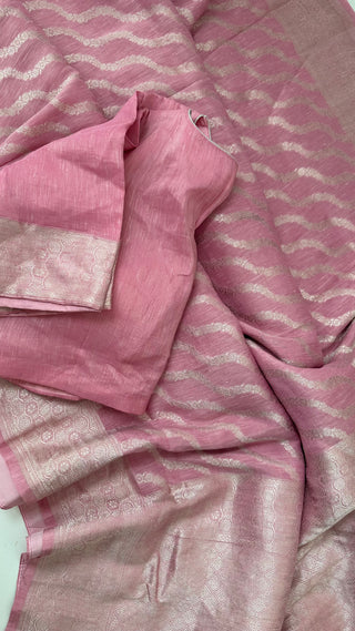 Handwoven pure linen Banarasi saree in soft pink tone featuring shimmering silver border, stitched blouse, and elegant drape.