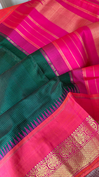 Bottle green Kanjivaram silk saree displayed with golden zari detailing