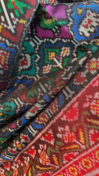 Pure silk Patan Patola saree showcasing detailed animal pattern weaving and smooth, lightweight drape