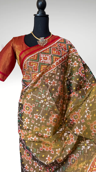 Authentic Patola silk saree woven using traditional techniques, featuring fine detailing, silk finish drape, and premium quality fabric.