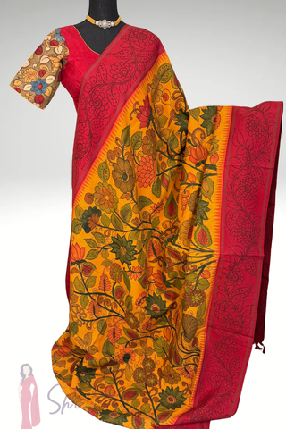 Premium green Kanchipuram silk saree with pure zari weaving, artistic hand painted pen kalamkari design and stitched blouse.