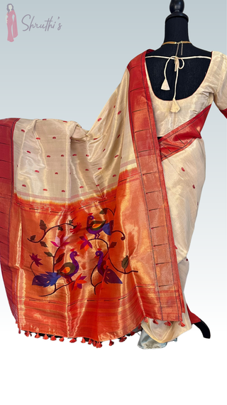 Elegant pastel Tissue Paithani silk saree with all-over zari weave and prestitched blouse, perfect for traditional occasions and gifting.