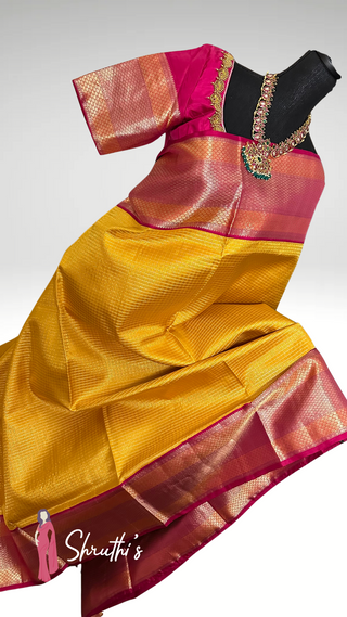 Yellow Kanjivaram silk saree with silver zari and blouse, bridal wear.