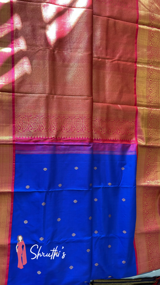 Bridal Kanjivaram silk saree in blue and pink with zari weave and embroidered blouse.