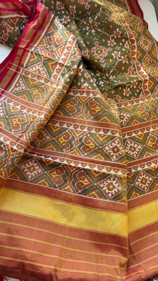 Beautiful Patola saree with smooth silk finish and iconic ikat motifs, offering a blend of heritage and elegance.