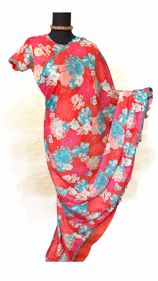 Pink satin crepe printed saree featuring soft floral patterns and a fully stitched high-neck blouse.