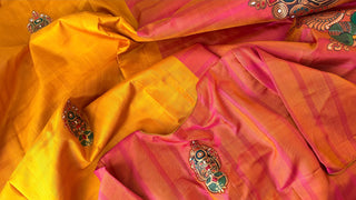 Tanjore painting yellow Kanjivaram saree with traditional gold zari pallu