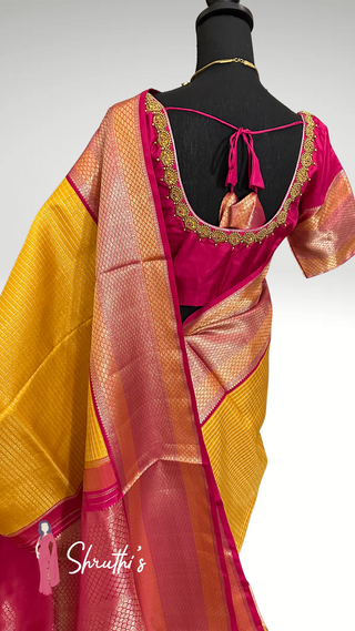 Elegant yellow silk brocade Kanjivaram saree with silver zari border.